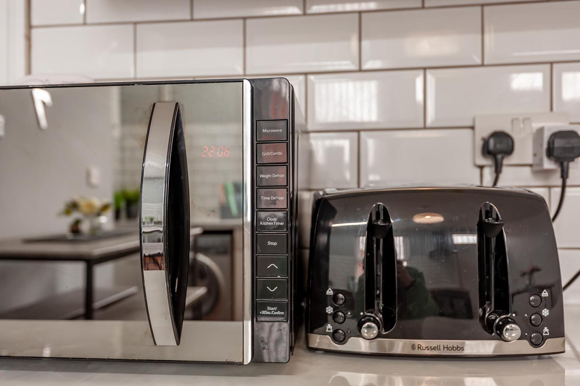 A kitchen with a microwave and a toaster.