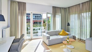 A modern living room with a sofa, a dining table, and a coffee table.