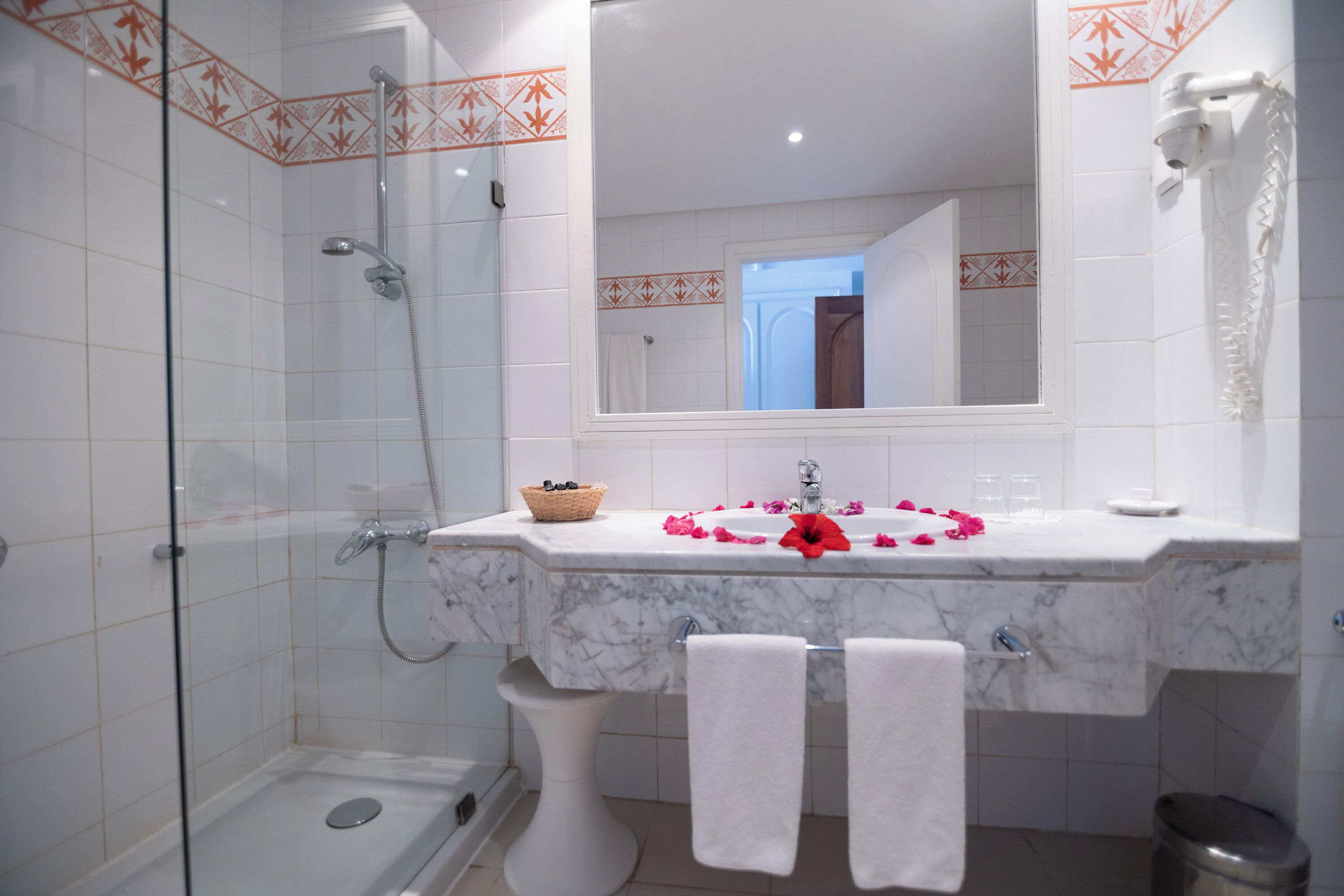 A bathroom with a shower, toilet, and sink.