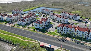 Zona residencial costera con edificios de varios pisos, una carretera y una masa de agua.