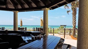 An outdoor seating area with a view of the beach and ocean. - Beachfront, 4th floor, Wrap Balcony, Great Views! (Panama City Beach)