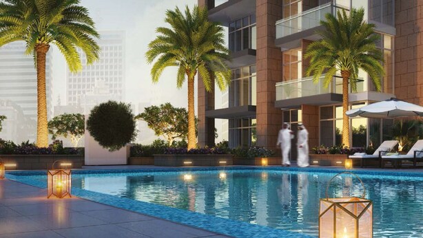 A modern hotel with a swimming pool, palm trees, and lounge chairs. - Nasma Luxury Stays - Riviera 10 (Dubai)