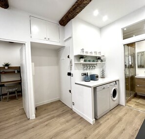 Enjoy cooking in this well-equipped kitchen with washing machine and ample countertop space.