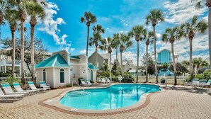 A pool area with lounge chairs and palm trees. - Andrea's Island*Golf Cart*Bikes*BeachSvc+ExtraGear! (DESTIN)