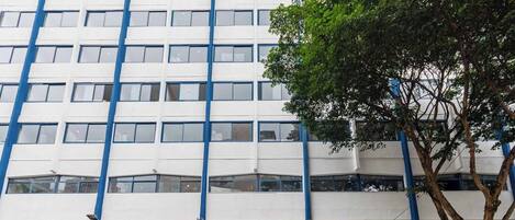 Un edificio a più piani con facciata a griglia ed elementi strutturali blu.