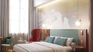 A modern hotel room with a large bed, a red armchair, a small round table, and a view of a mountainous landscape through the window. - Baron Amédée Armand Hotel & Spa Marseille - Mgallery (Marseille)