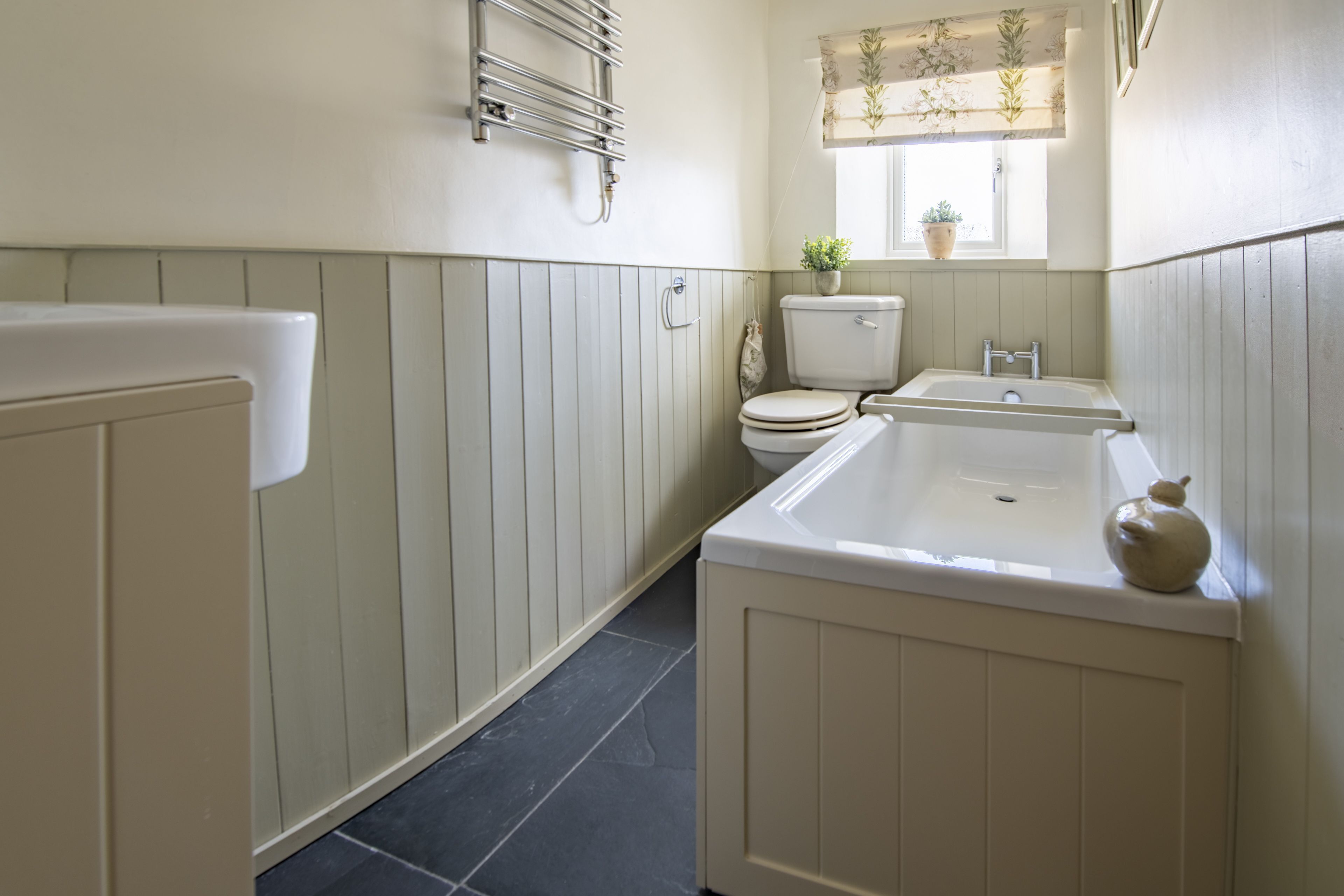 A bathroom with a bathtub, a toilet, and a sink.