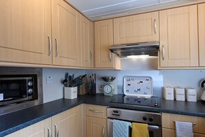 Fridge, high chair, cookware/dishes/utensils