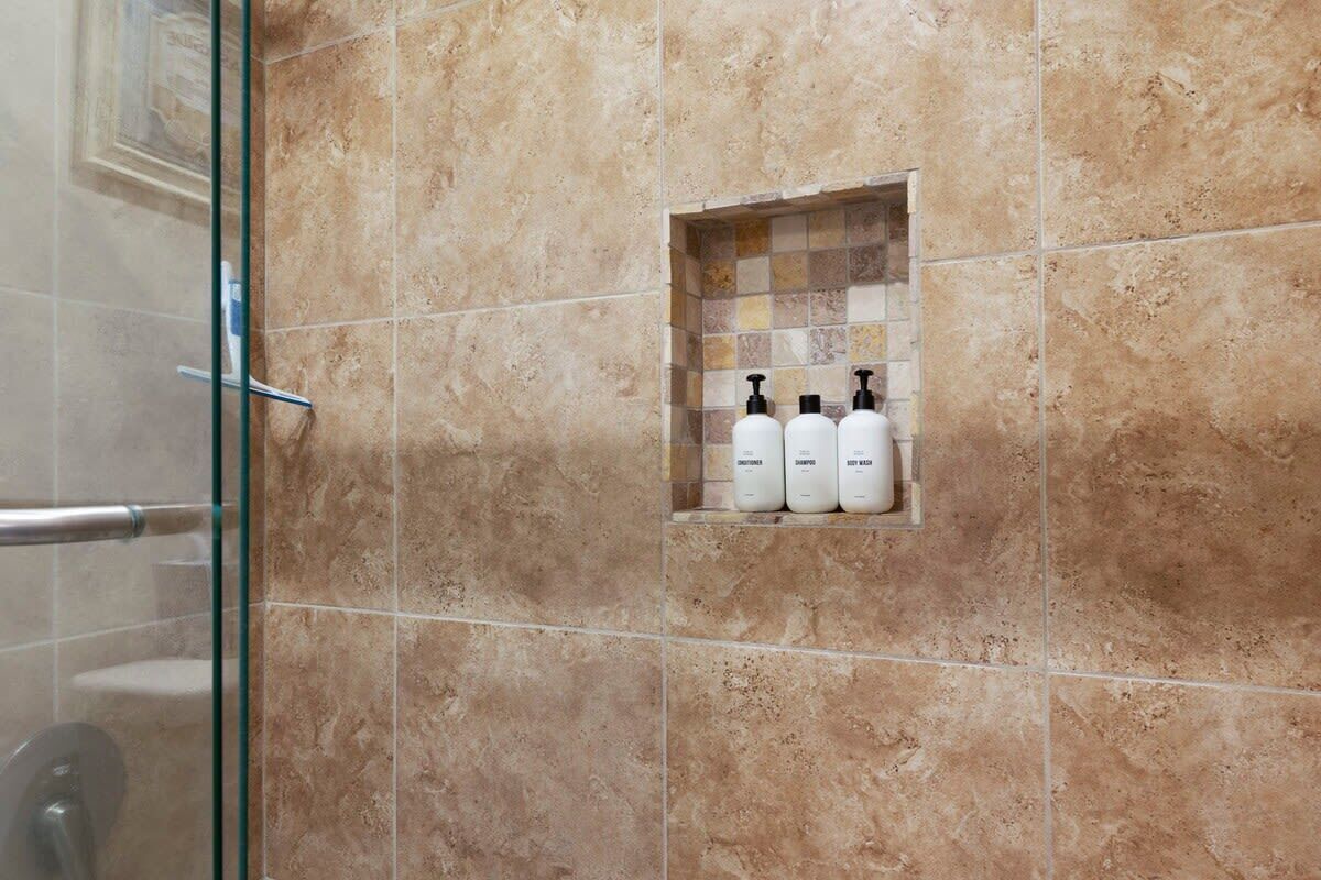 Bathtub, hair dryer, towels, shampoo