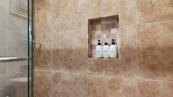 Bathtub, hair dryer, towels, shampoo