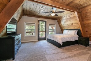 A bedroom with a sloped ceiling, a bed, a dresser, and a ceiling fan. - Rustic & Modern 3BDR Tahoe Cabin (Tahoe City)