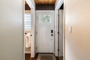 A white door with a small window, a towel hanging on the wall, and a wooden floor. - Rustic & Modern 3BDR Tahoe Cabin (Tahoe City)