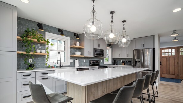 A modern kitchen with a large island, bar stools, and pendant lighting. - 409 Paynter Avenue - In town Lewes with a private pool! (Lewes)