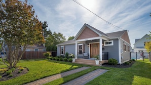A single-story house with a front porch, a small garden, and a paved driveway. - 409 Paynter Avenue - In town Lewes with a private pool! (Lewes)