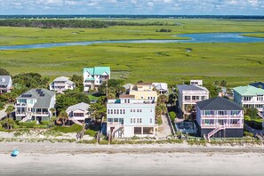 A coastal residential area with houses, a beach, and a river.