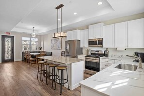 Enjoy cooking in this well-equipped kitchen with a central island and bar stools.