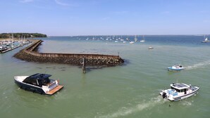 A marina with boats docked and a pier extending into the water. - The Stables (Newport)