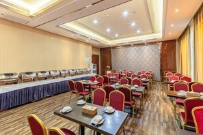 A conference room with rows of tables and chairs, a buffet setup, and a large window. - Vienna Hotel (Yongzhou Jianghua) (Jianghua)