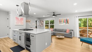 A modern kitchen with a large island, built-in appliances, and pendant lighting. - Modern, Cozy Buckhead 4+3 SFH + Backyard (Atlanta)