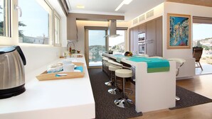 A modern kitchen with a large island, bar stools, and a view of the city. - Villa Nelmar, Luxury Villas in Anavyssos (Athens)