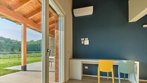 A modern room with a large window, a desk, and a chair. - Melograno Apartment - Poggio le Crete (Soiano)