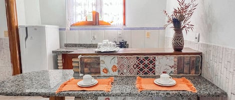 Standard Apartment | Private kitchen | Mini-fridge, stovetop, cookware/dishes/utensils, dining tables