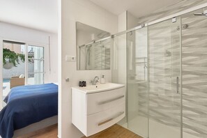 Shower, hair dryer, towels, toilet paper