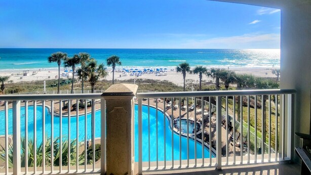 A pool area with a view of the beach and ocean. - Beachfront Bliss! 4th-Floor Condo 2BR/2BA Sleeps 8! Steps from the water! (Panama City Beach)