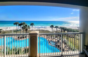A pool area with a view of the beach and ocean. - Beachfront Bliss! 4th-Floor Condo 2BR/2BA Sleeps 8! Steps from the water! (Panama City Beach)