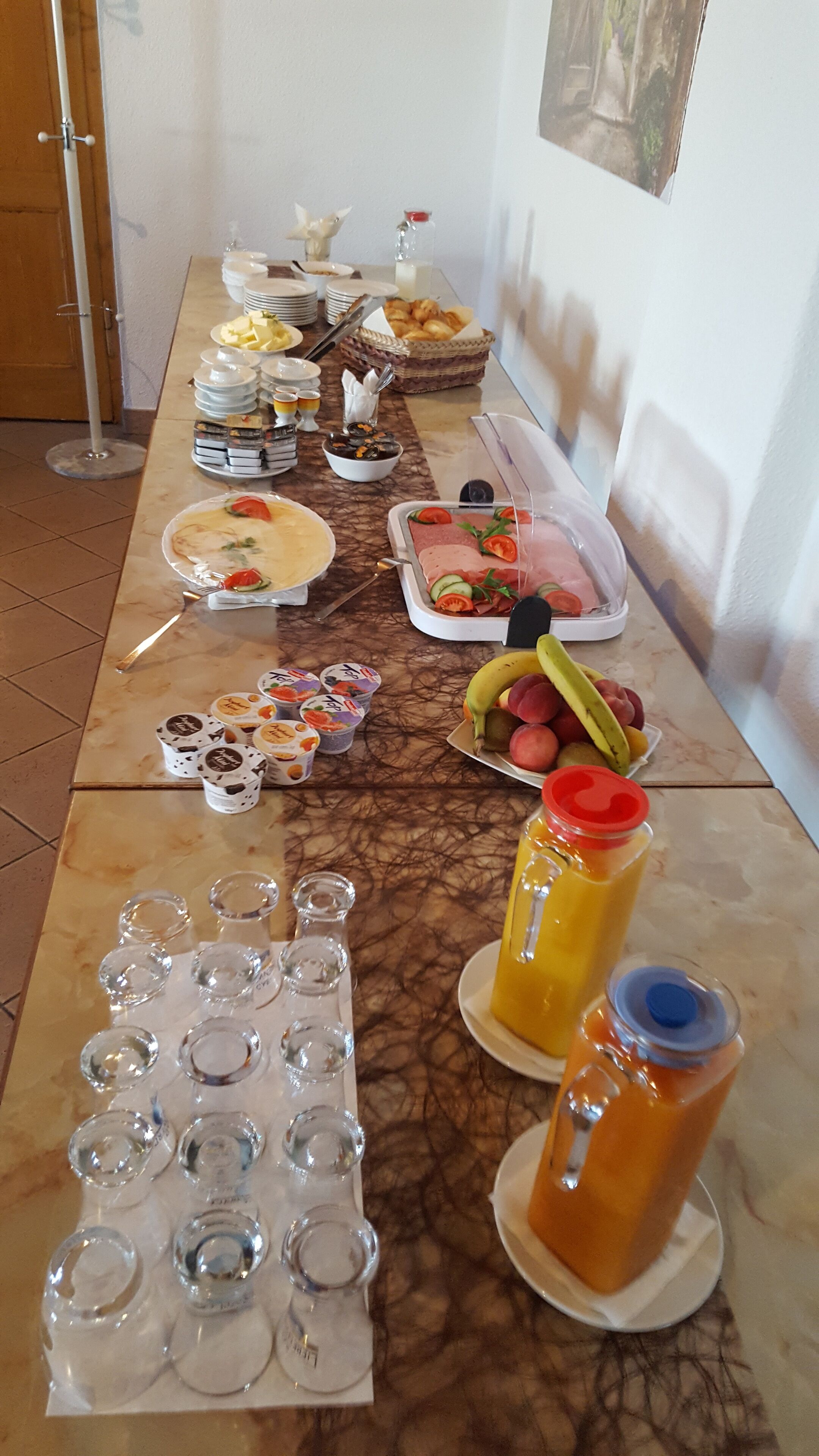 A buffet table with various food items and beverages.
