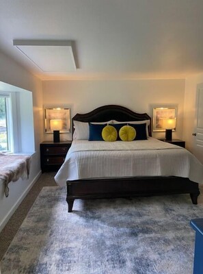 Cozy retreat with a large bed, bedside tables, and lamps.