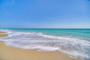A beach with clear turquoise water and a sandy shore. - Hutchinson Island Vacation Rental w/ Beach Access! (Fort Pierce)