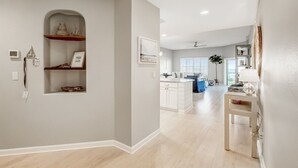 A modern kitchen with white cabinetry, a built-in oven, and a central island. - Ocean Park 318 Harbor Point - Hosted By Moore AI Rentals (Fernandina Beach)