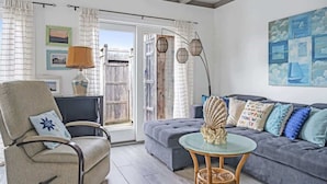 A cozy living room with a sofa, armchair, and a small table with a decorative item.