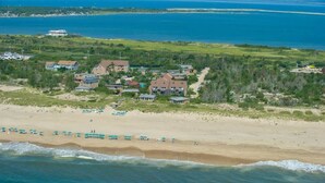 A coastal property with multiple buildings, a sandy beach, and a view of the ocean. - Unit 2022: 1-Bedroom with Loft | 2nd Floor-Bay View | Court Side (Amagansett)