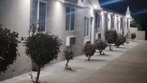 A modern building with a row of windows and a central entrance. - Stafford Inn (Redwood City)