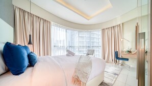 Une chambre d’hôtel moderne avec un grand lit, un bureau et une vue sur la ville.