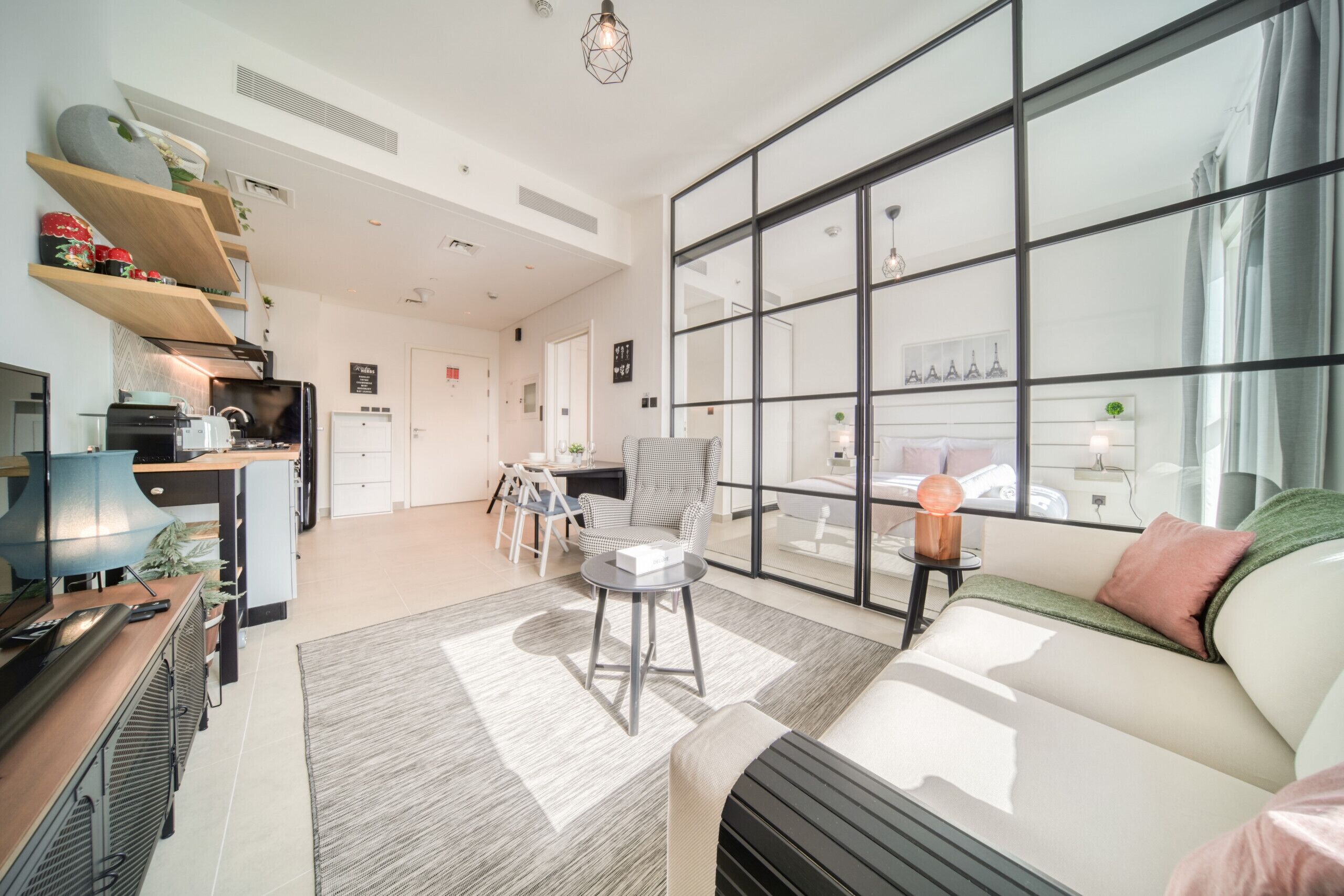 Una sala moderna con sofá, comedor y cocina.