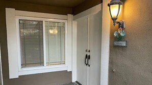 A front door with a white frame, a glass door, and a welcome sign. - Sweet 3 Bedroom condo in Hacienda Heights (Hacienda Heights)