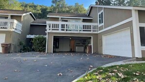 A two-story residential building with a garage and a balcony. - Sweet 3 Bedroom condo in Hacienda Heights (Hacienda Heights)