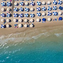 On the beach, white sand, sun-loungers, beach umbrellas