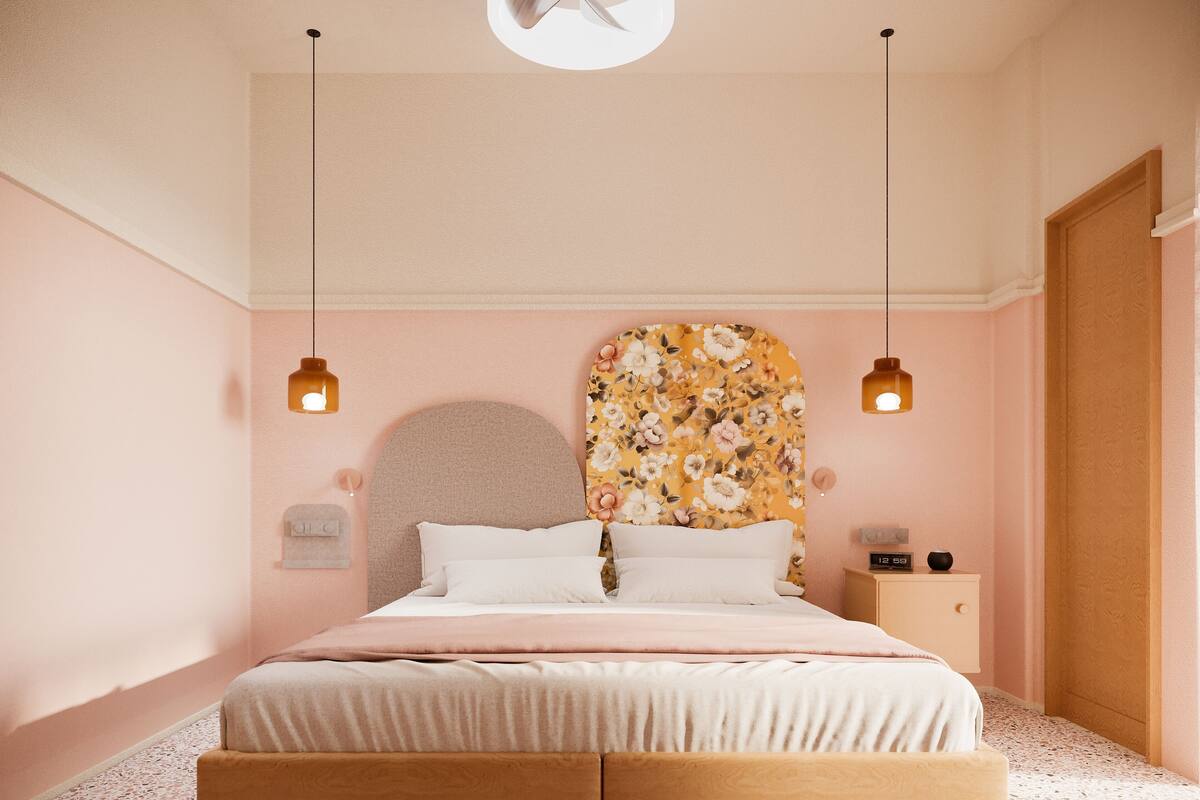 A bedroom with a bed, two bedside tables, a wall clock, and a ceiling fan.