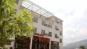 A multi-story building with a signboard indicating a restaurant.