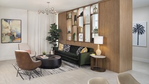 A modern living room with a green sofa, two armchairs, a coffee table, and a decorative wooden panel with shelves. - Mint House St. Petersburg Downtown by Kasa (St. Petersburg)