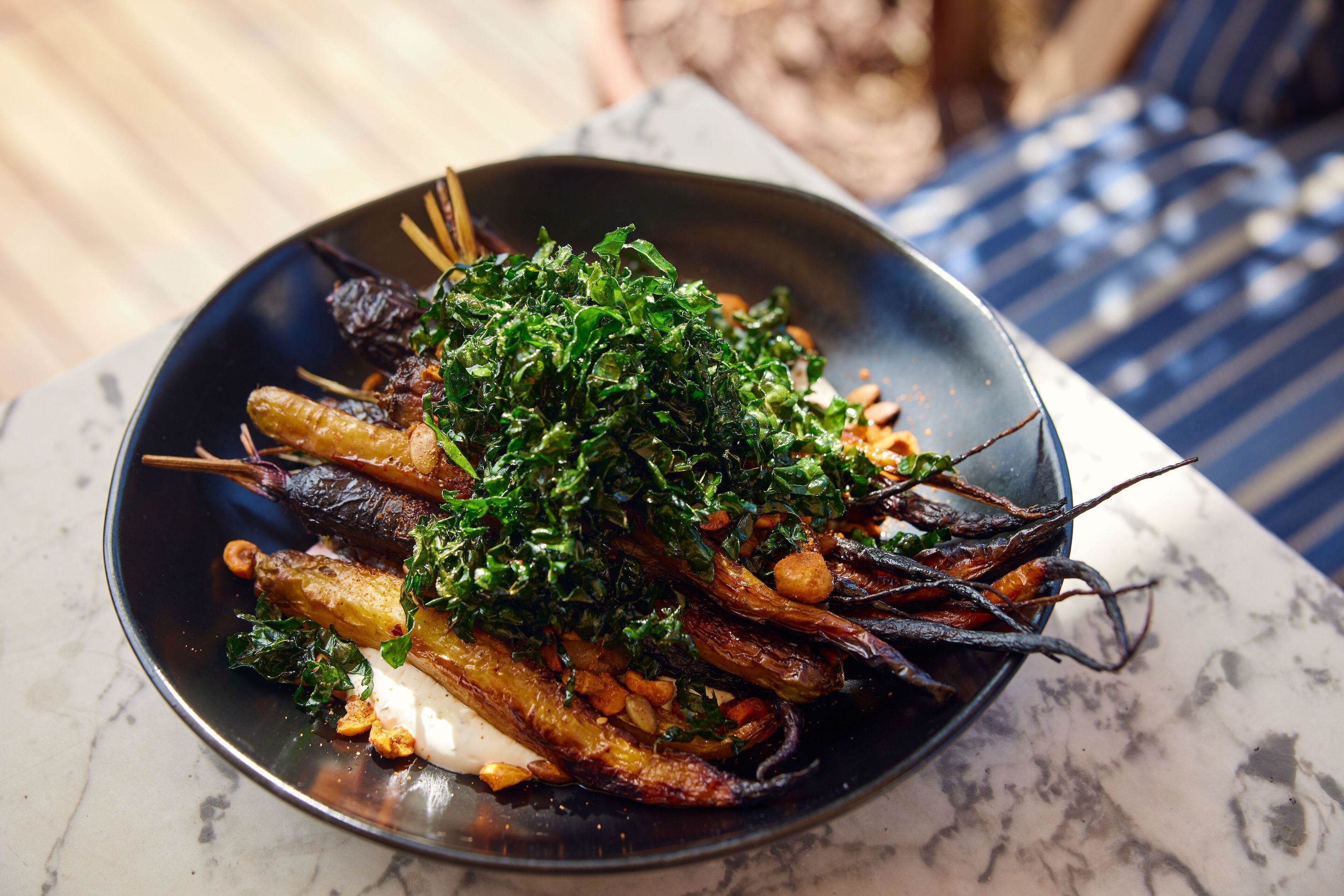 A plate of food with vegetables and herbs.