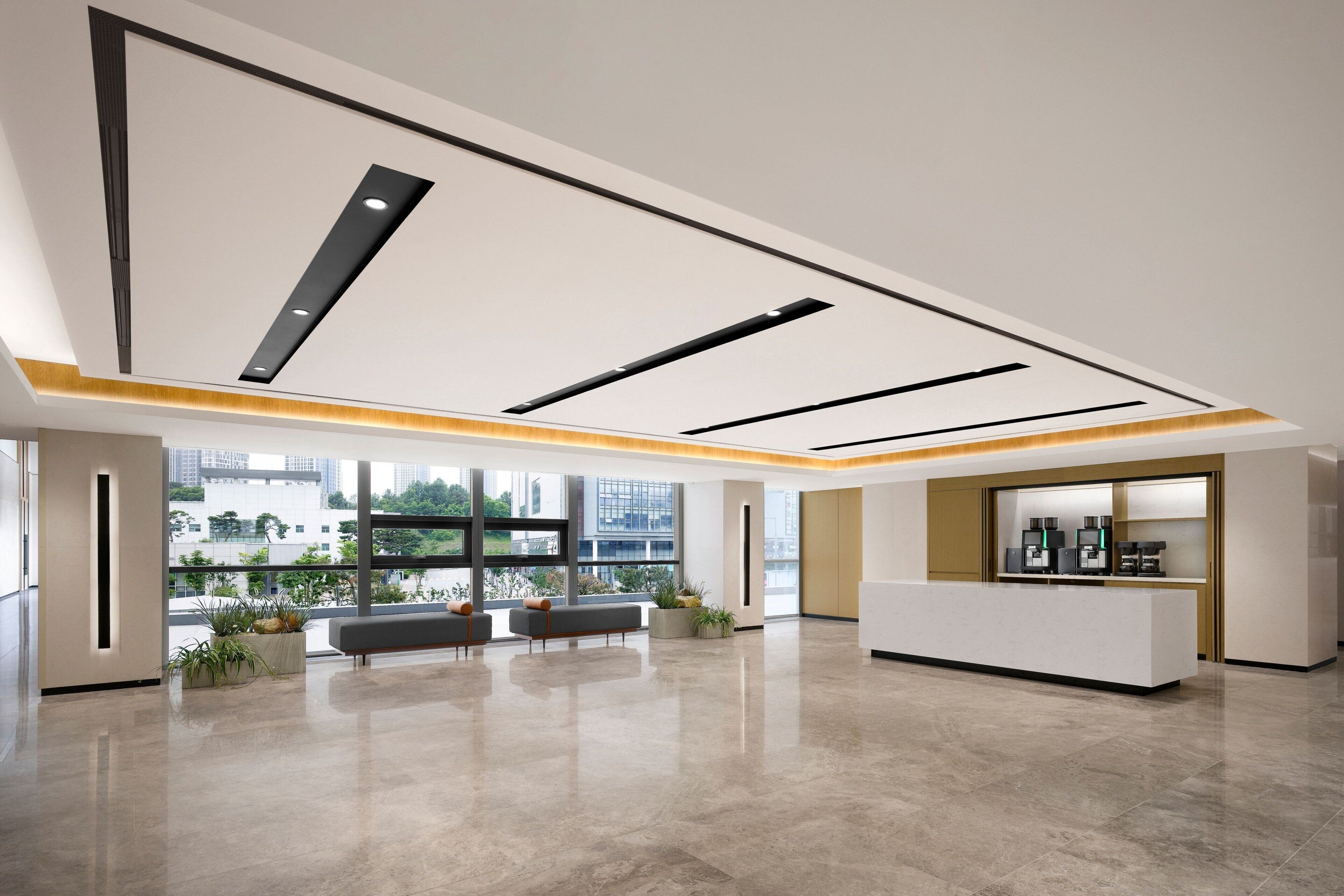 A spacious lobby with a reception desk, seating area, and large windows offering a view of the cityscape.