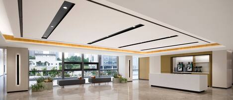 A spacious lobby with a reception desk, seating area, and large windows offering a view of the cityscape.