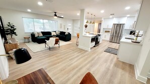 A modern kitchen with a built-in oven and a stainless steel refrigerator.