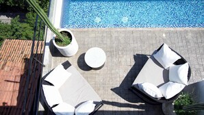 An outdoor pool area with lounge chairs and a cactus plant. - Loft 302 Summary:<br>We (Puerto Vallarta)