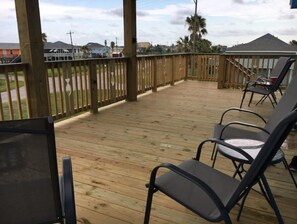 Relax in a serene outdoor space with comfortable seating and a view of the surrounding neighborhood.